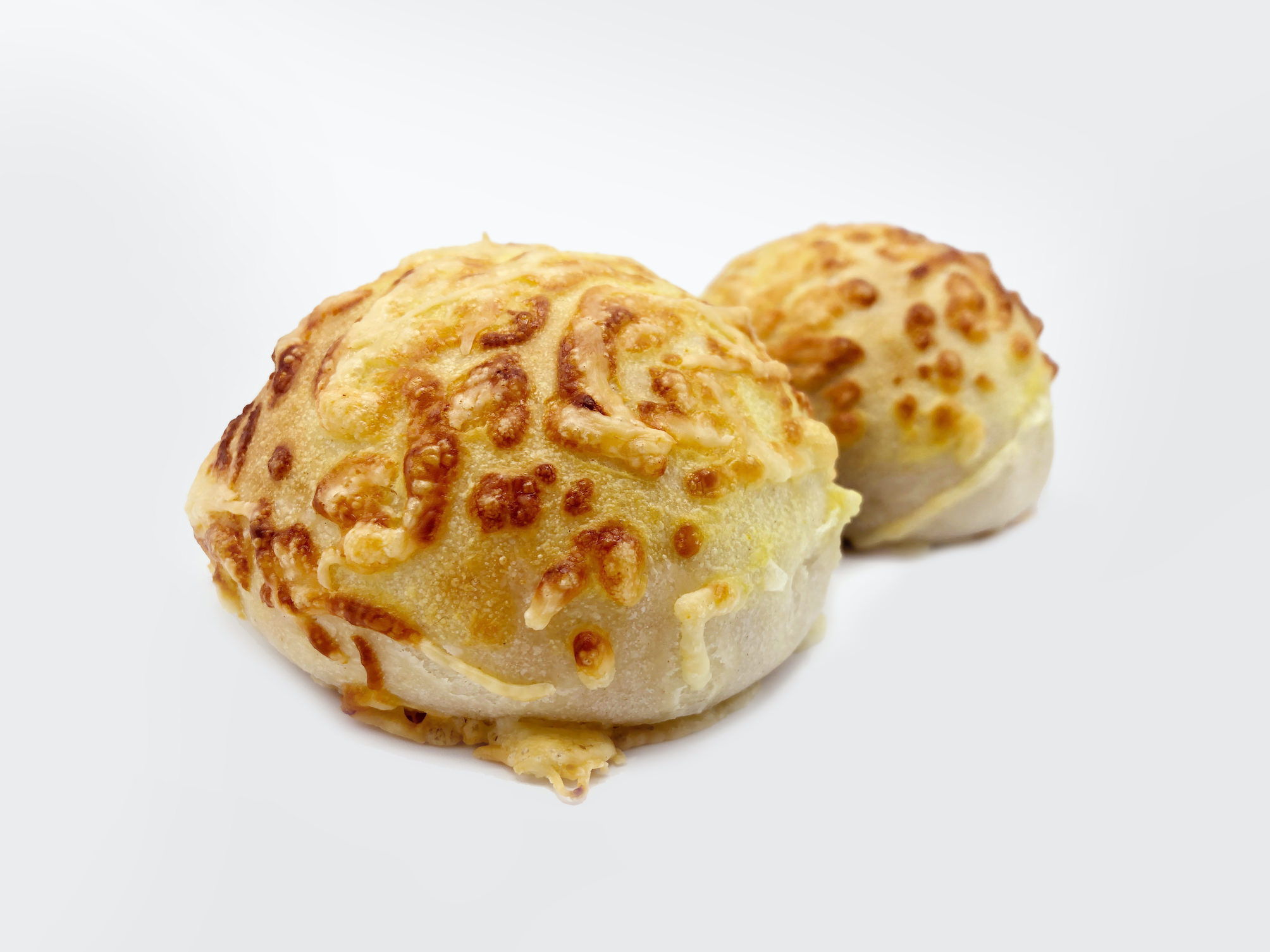 Two buns covered with cheese made with FoodJet food depositor