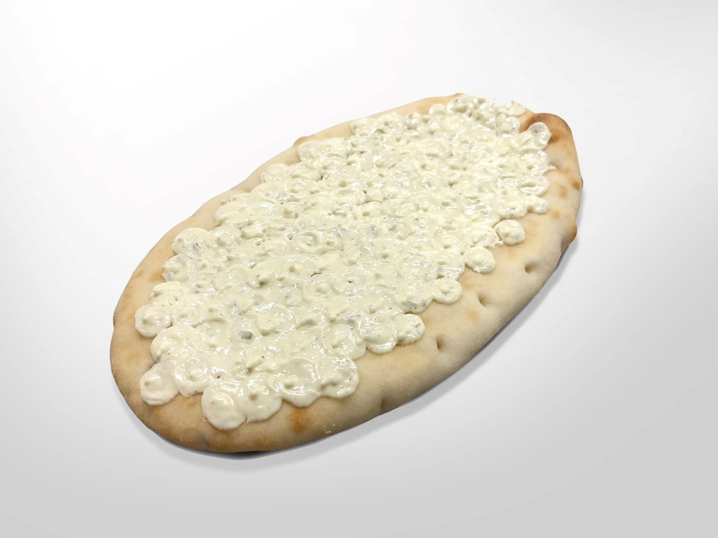 Garlic sauce deposited on flatbread