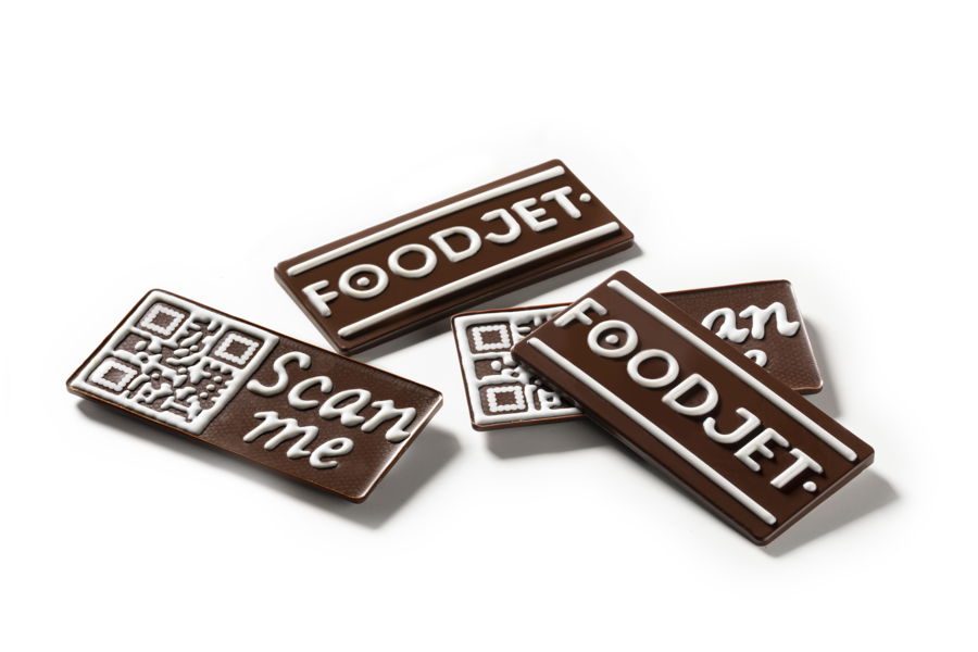 4 multi-layer complex milk chocolate bars decorated with white chocolate created by a FoodJet precision depositing system