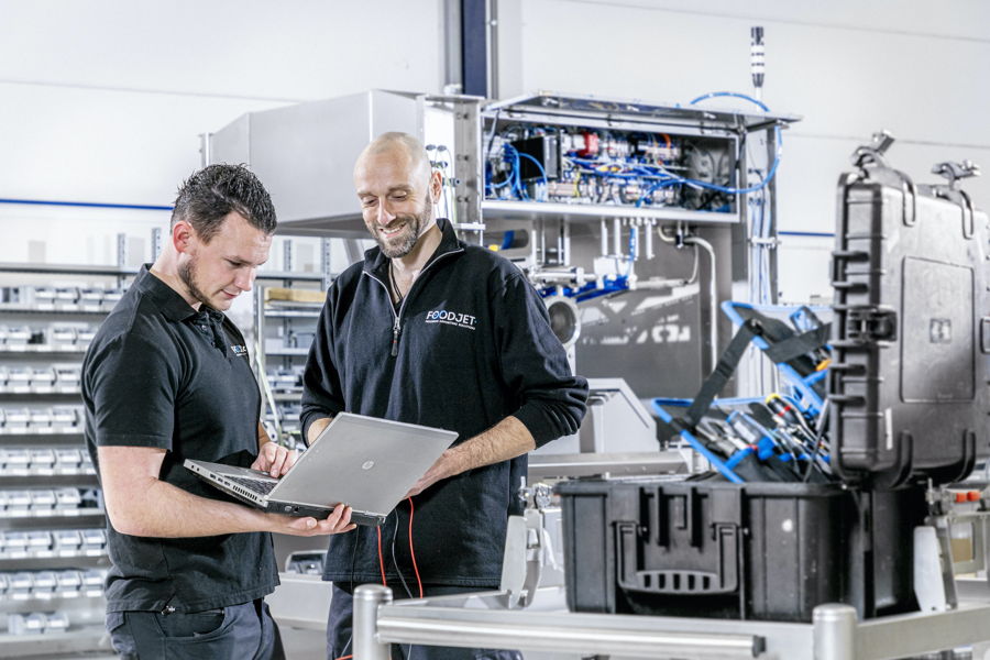 FoodJet service engineers holding a laptop
