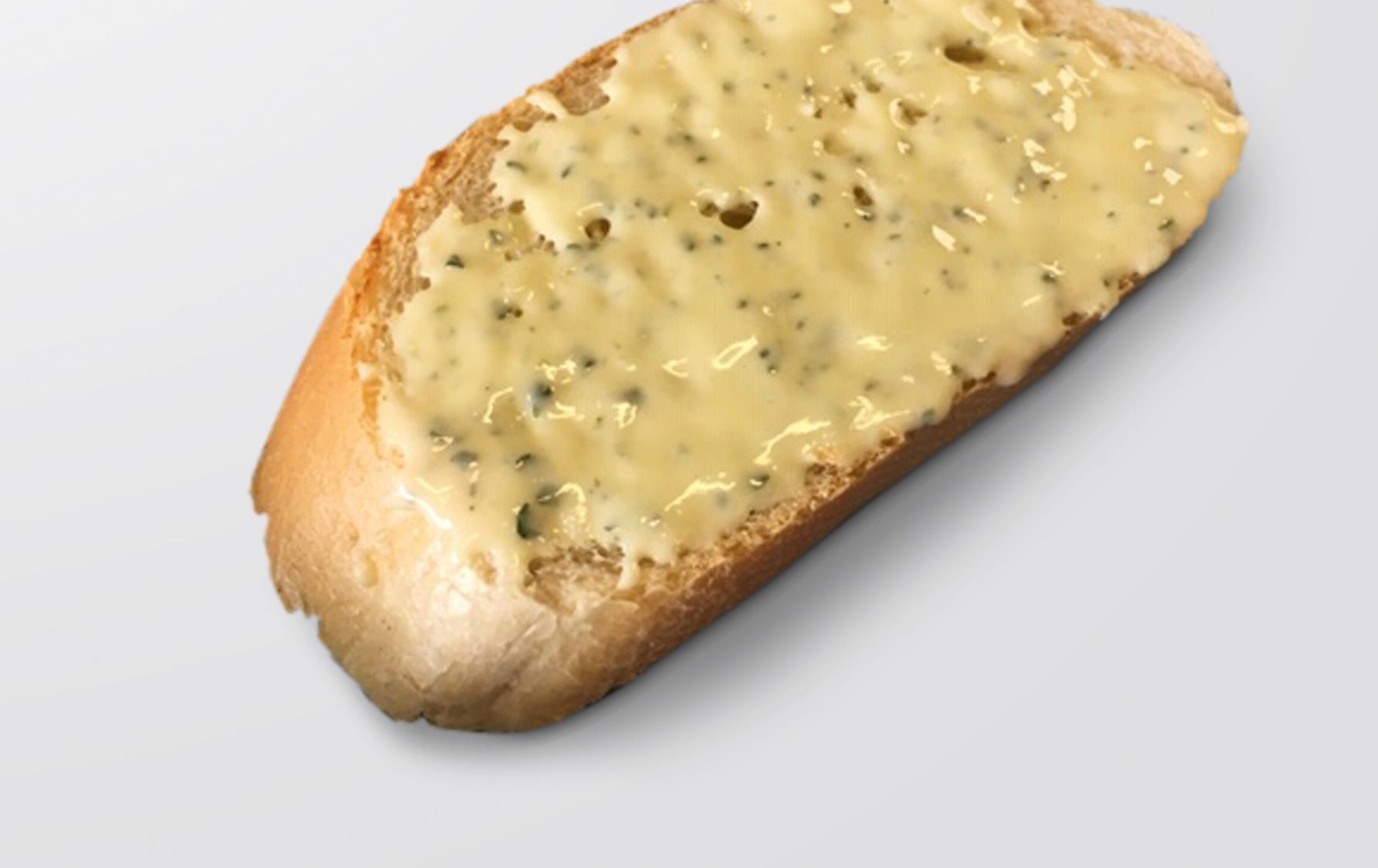 Piece of bread with garlic butter neatly applied by FoodJet garlic butter depositor