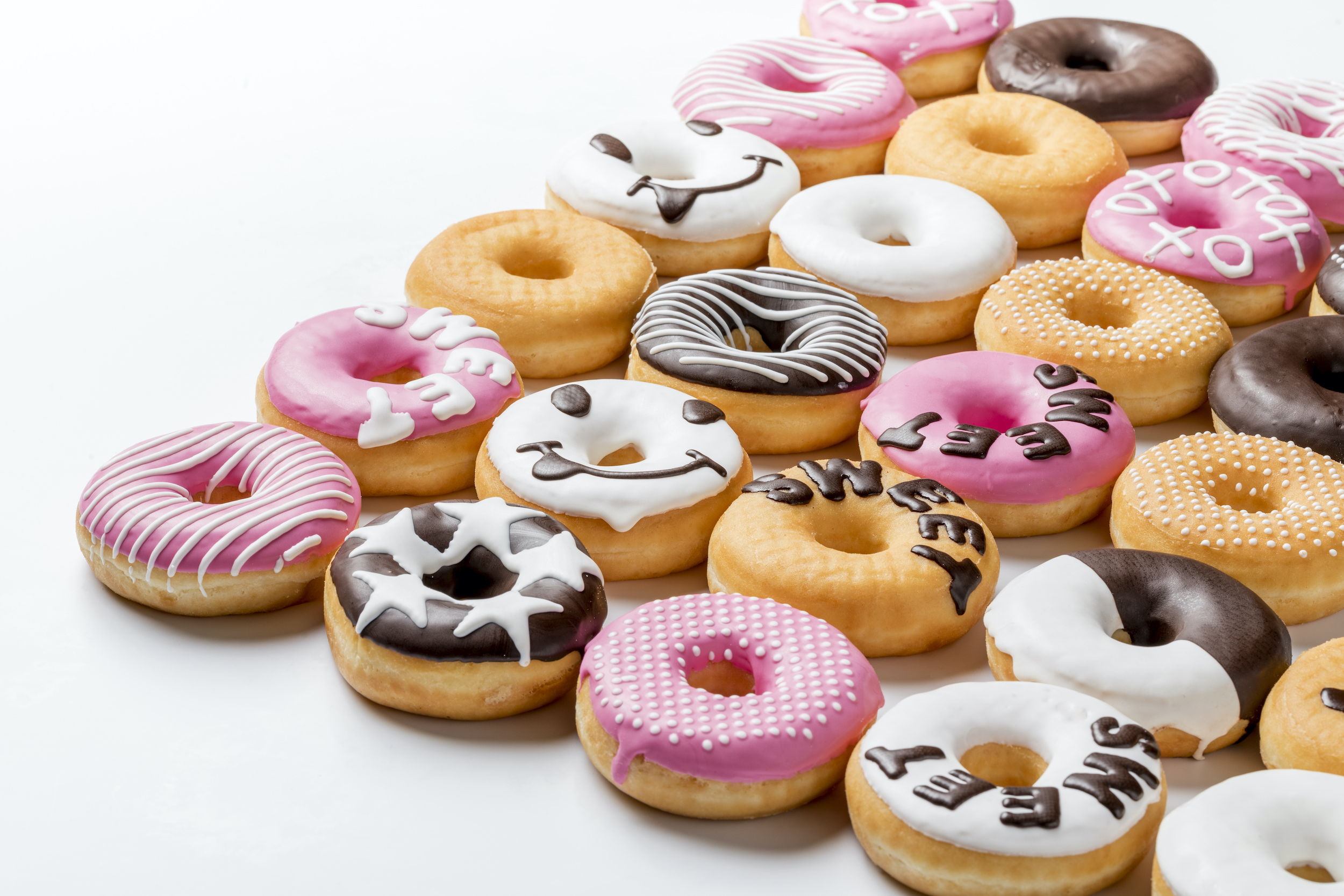Donuts graphically decorated with fat compound