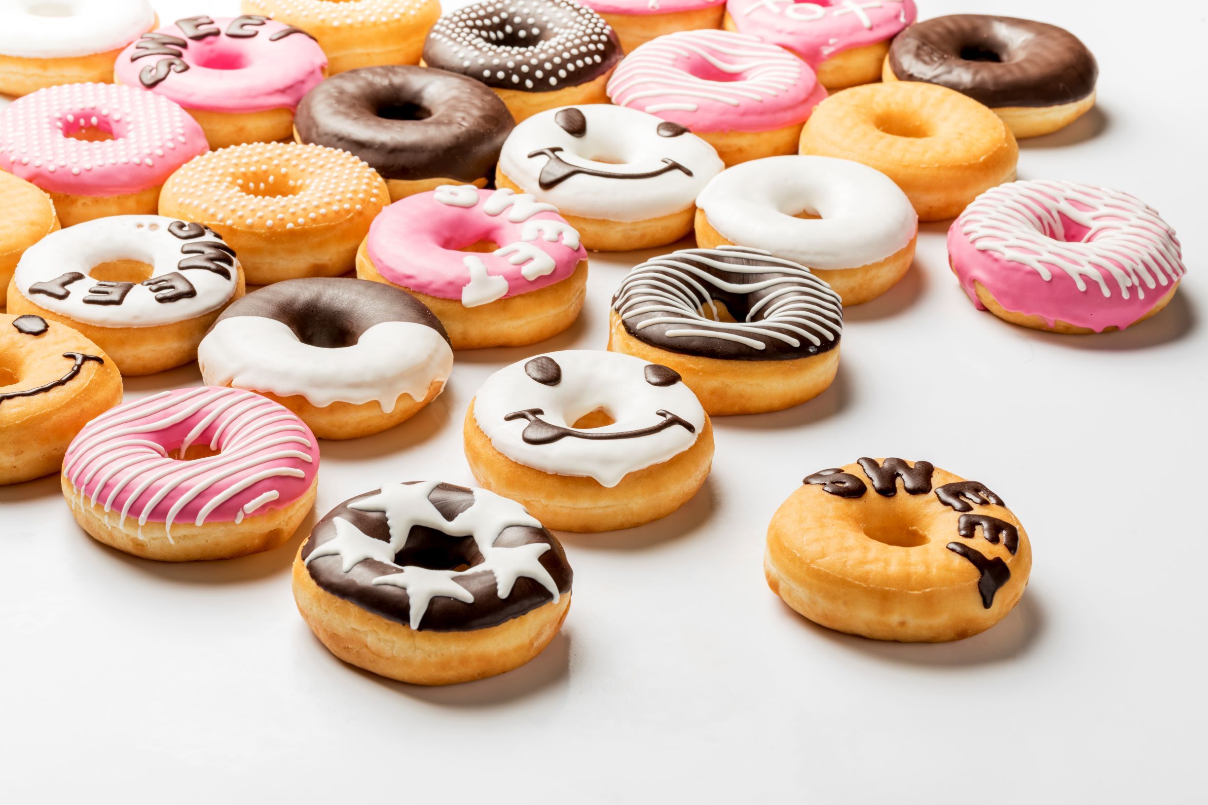Wide range of chocolate decorated donuts made with FoodJet chocolate depositor