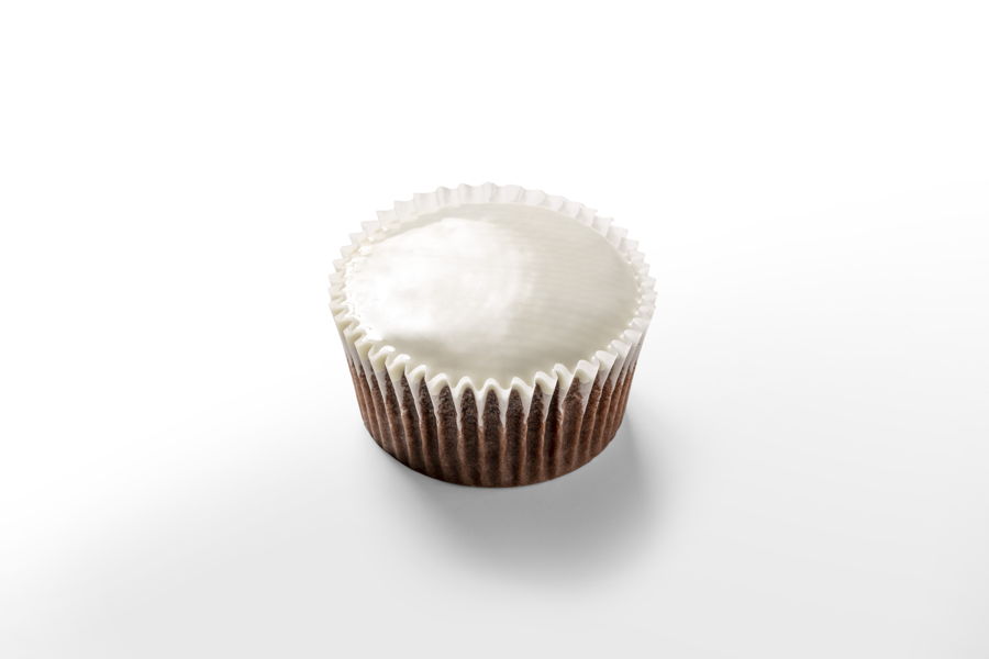 Brown cupcake covered with white chocolate by a FoodJet precision depositing system