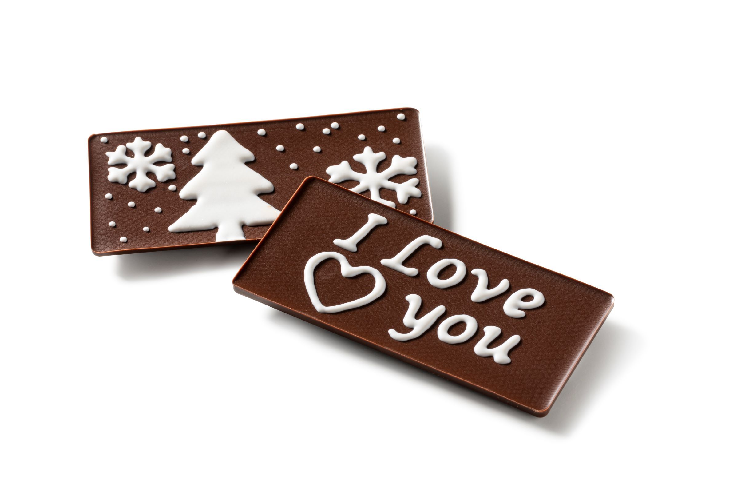 Two milk chocolate tablets decorated with a christmas tree and I love you - printed by a FoodJet chocolate depositing system