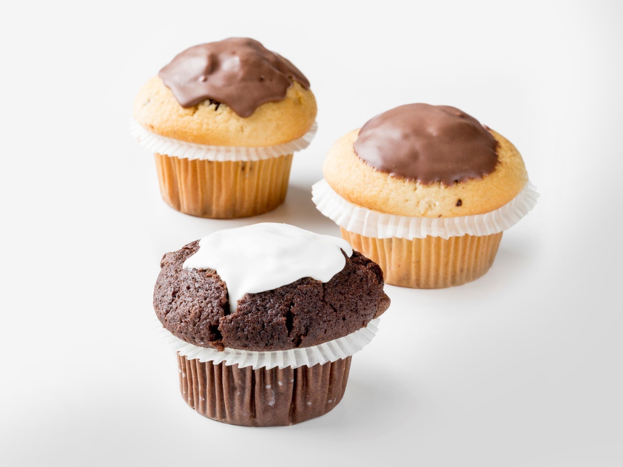 Three muffins topped with chocolate