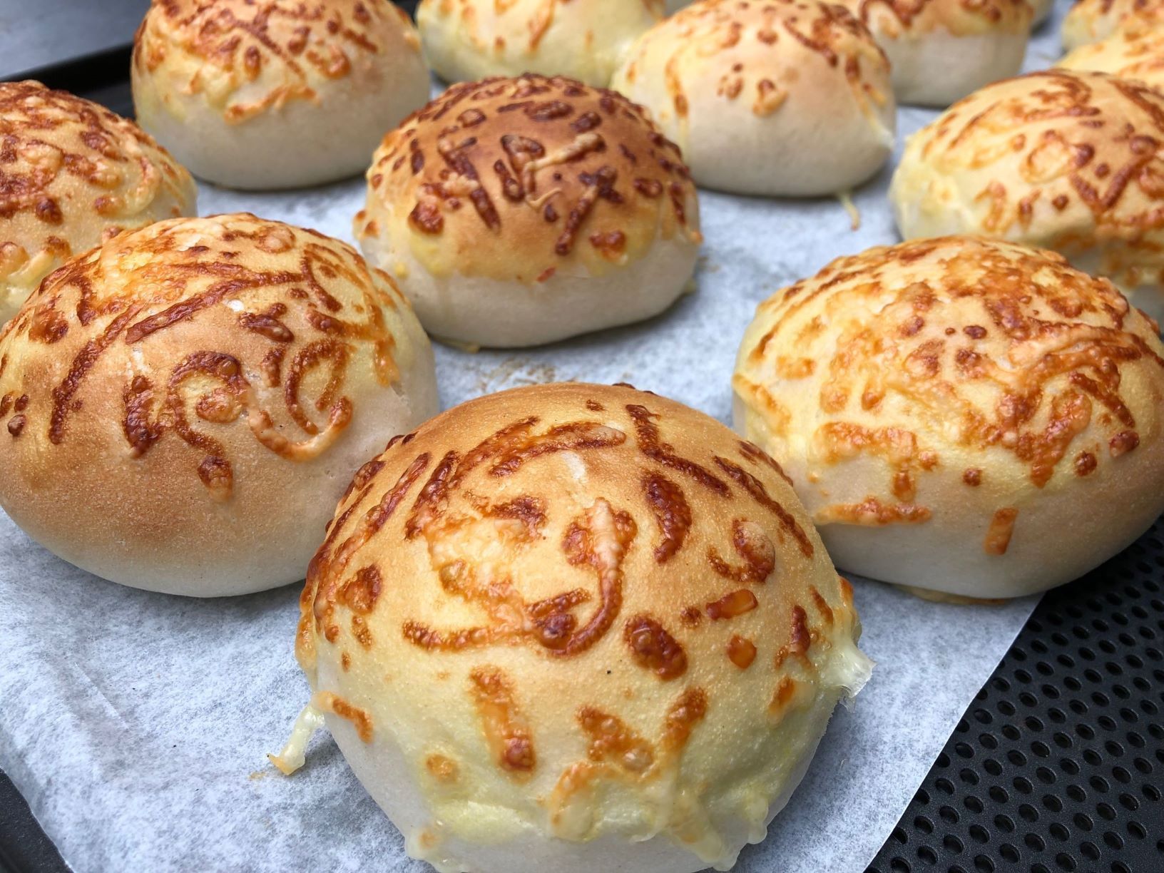 Buns covered with cheese by FoodJet cheese depositor