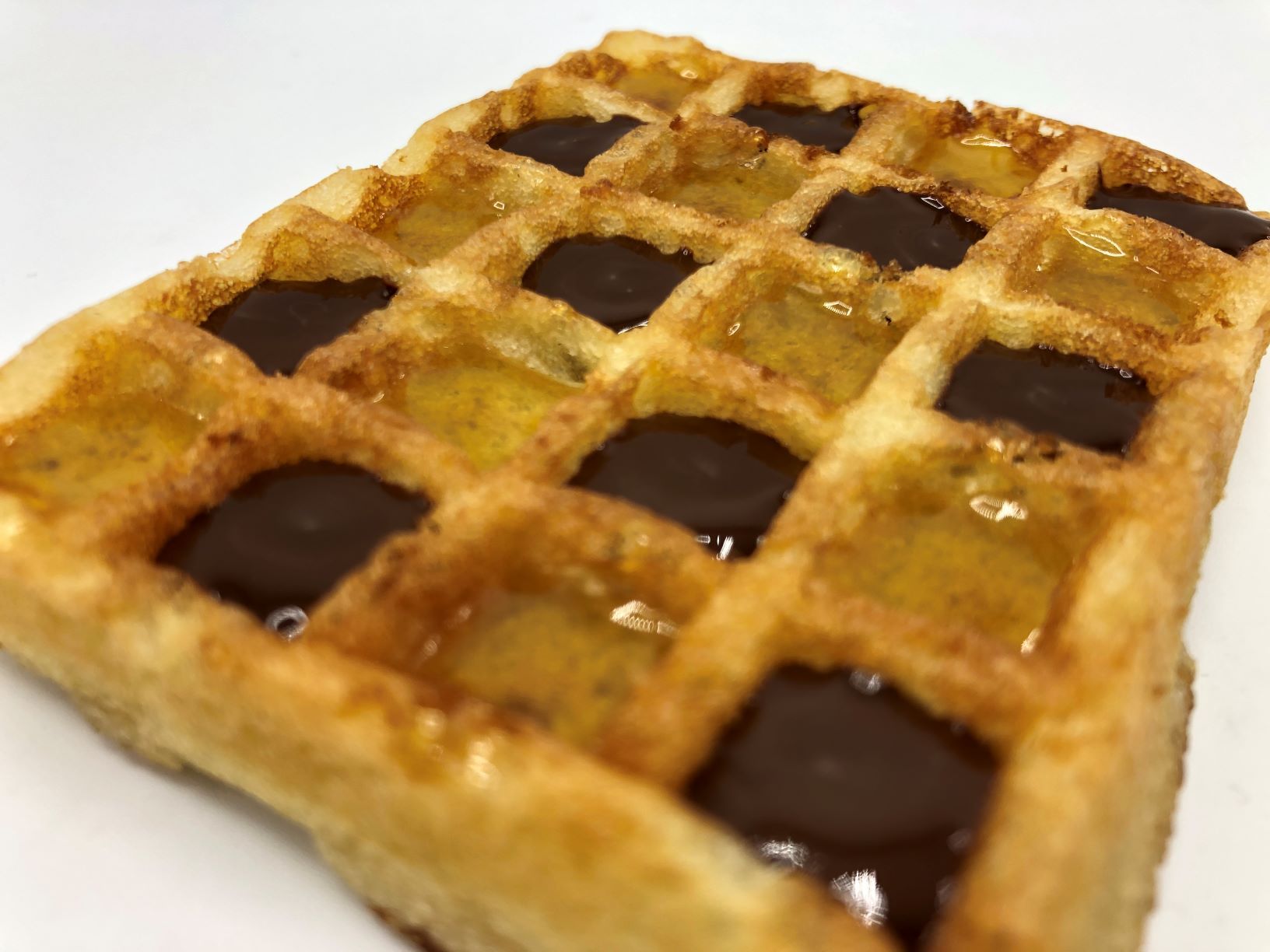 Egg waffle filled with marmalade and chocolade by FoodJet chocolate depositor