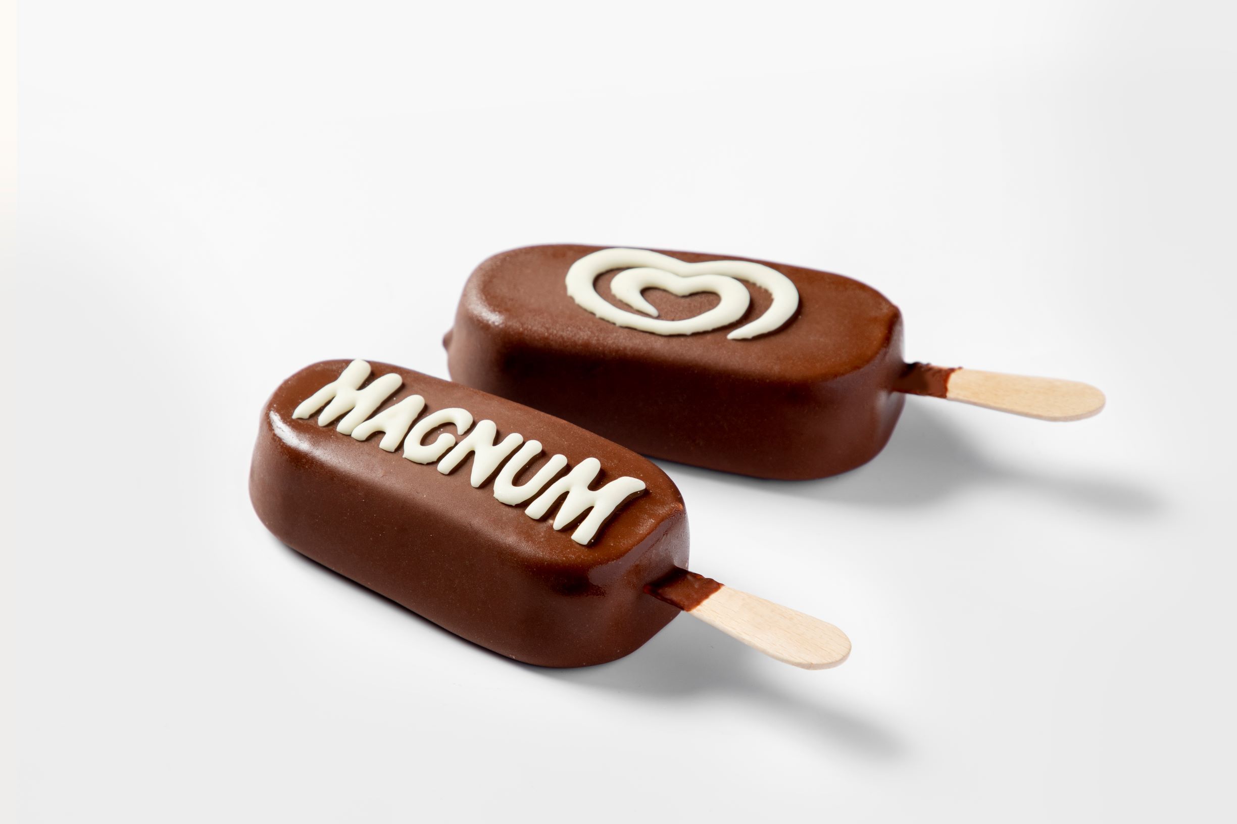 Two Magnum-type ice creams decorated with white chocolate by FoodJet chocolate depositor