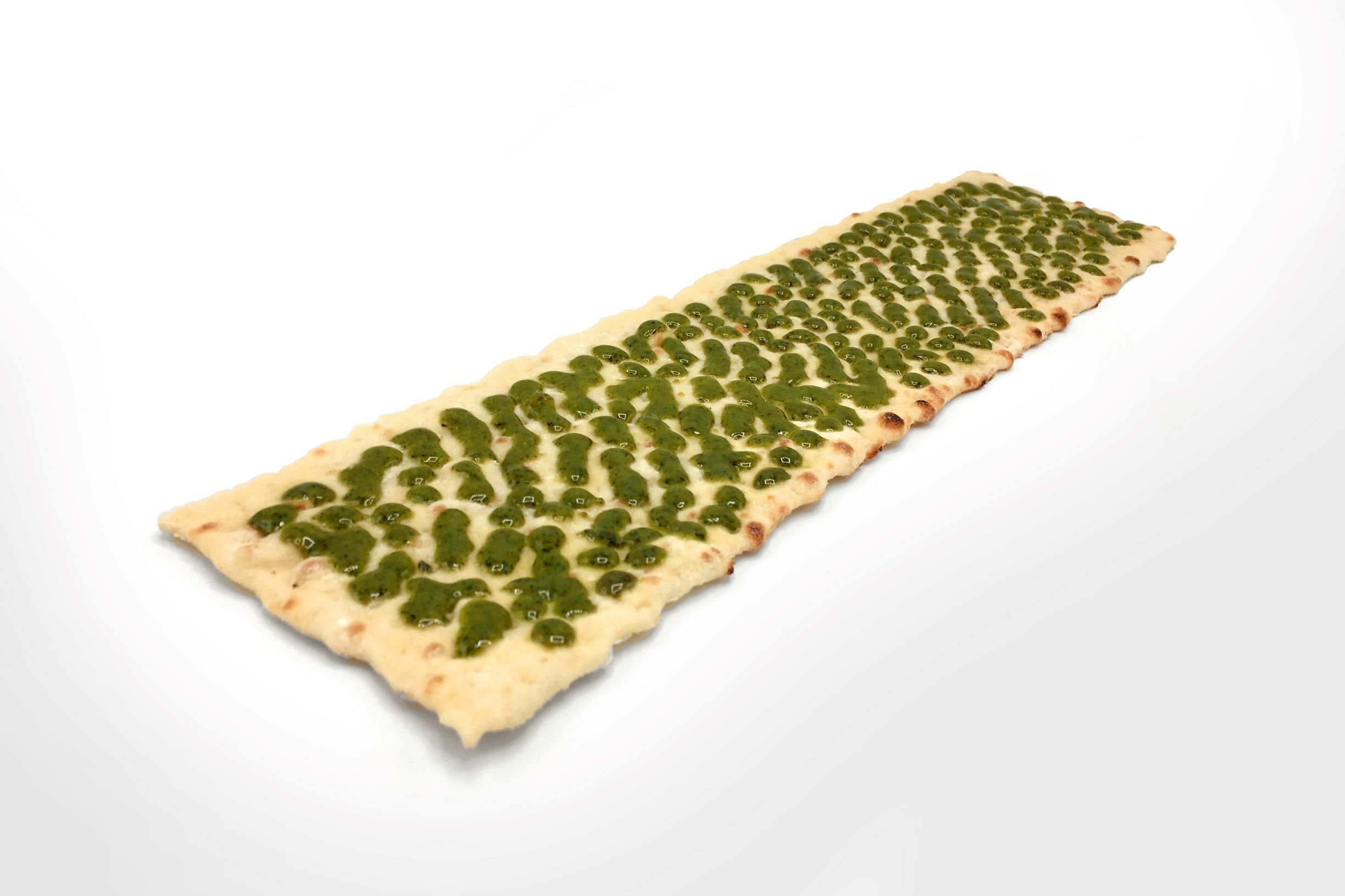 Flatbread with pesto sauce evenly applied by FoodJet sauce depositor