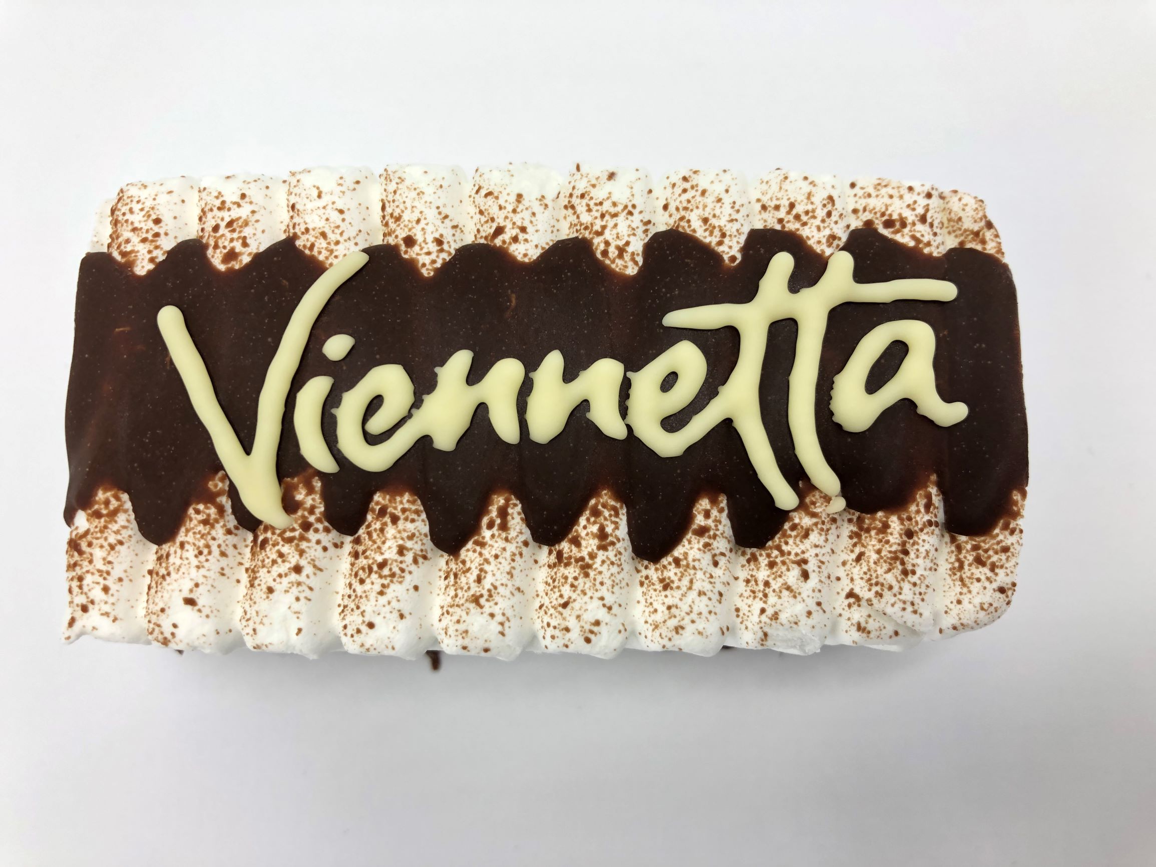 Viennetta ice cream decorated with white chocolate by a FoodJet chocolate depositor