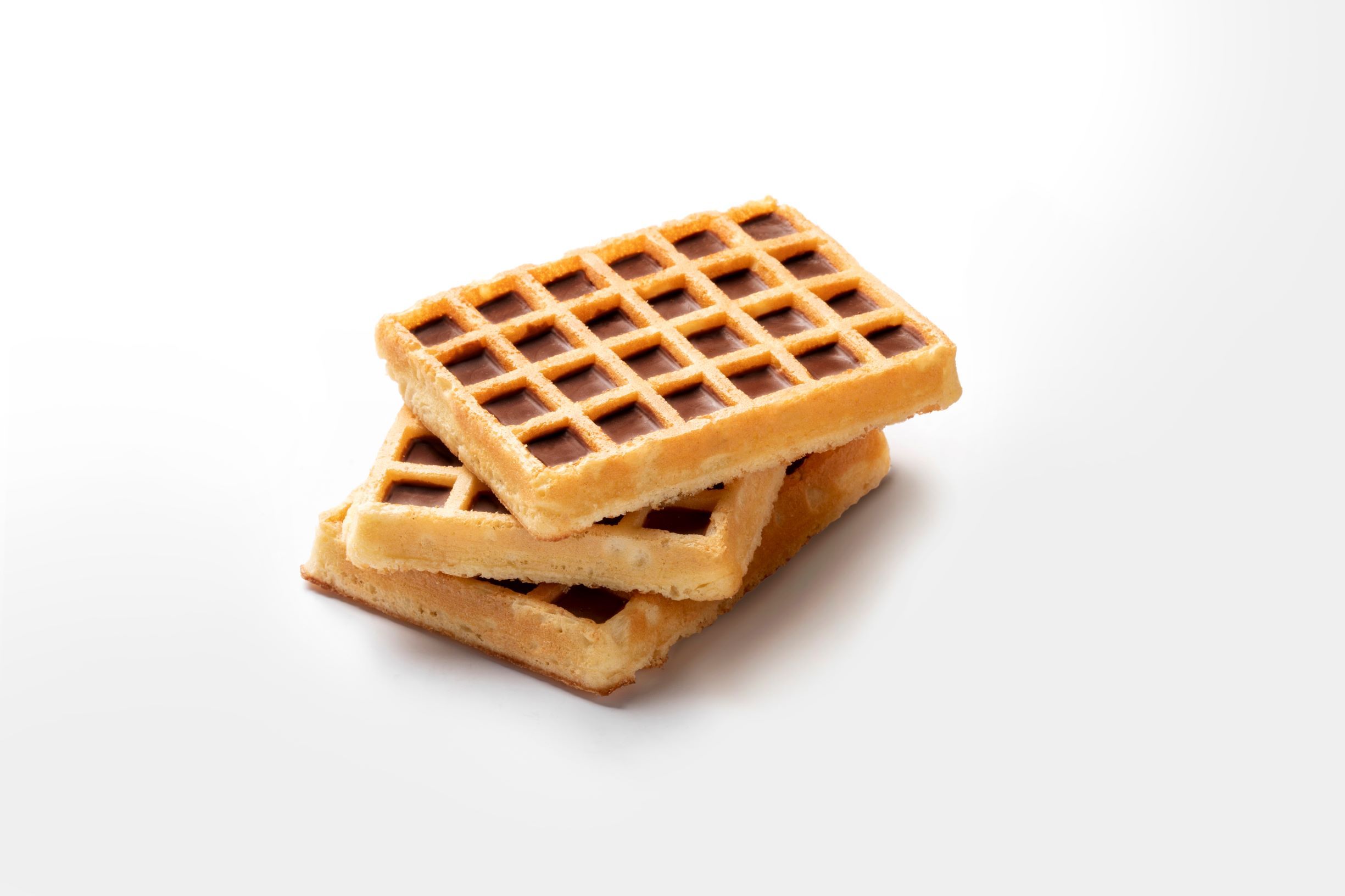 Pile of three egg waffles topped with chocolate by FoodJet chocolate depositor