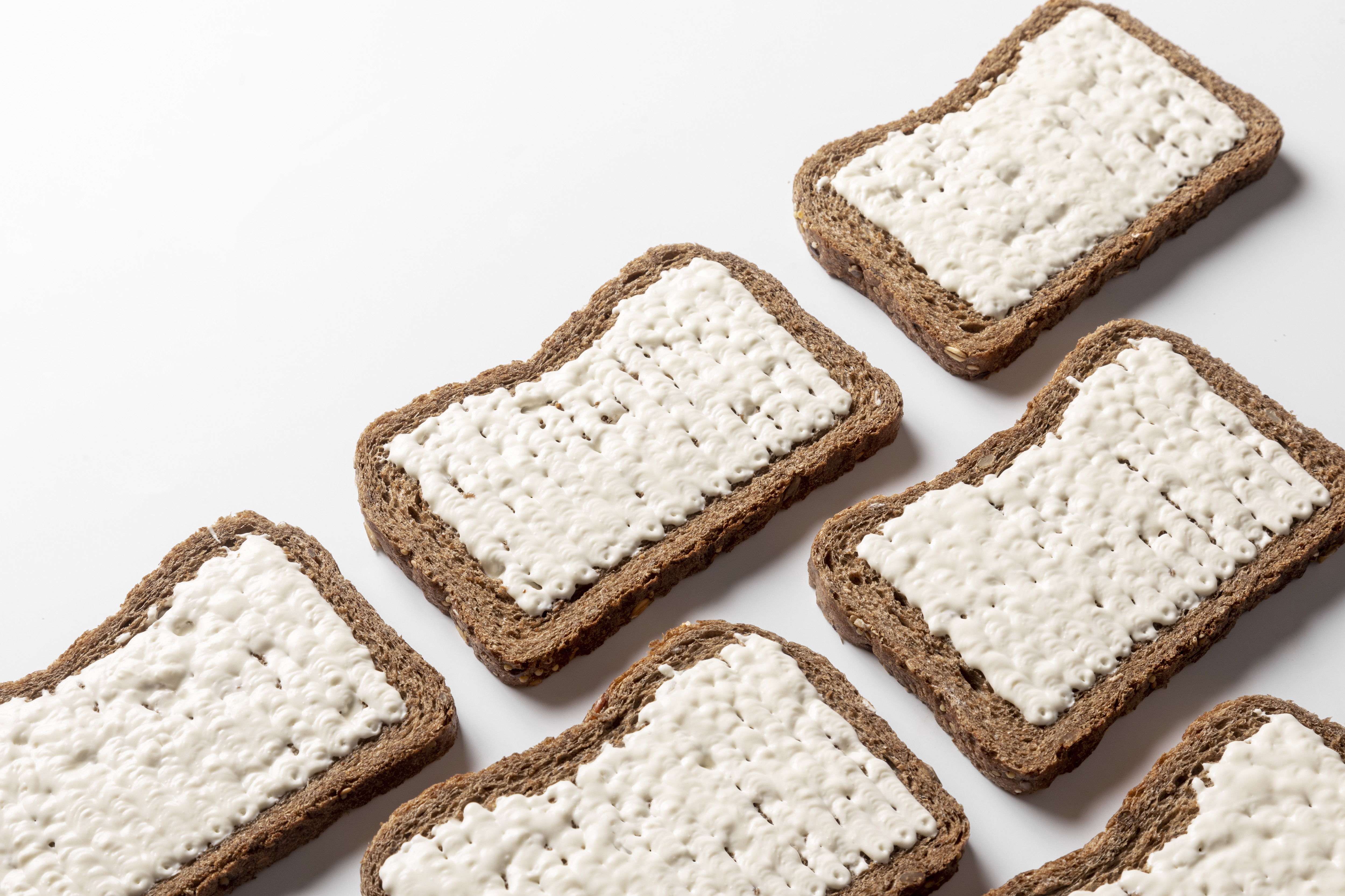 Butter deposited onto a slice of bread