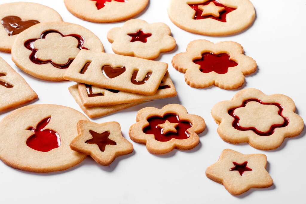 Biscuits with jam in cut-out shapes: flowers, stars, an apple and I love U